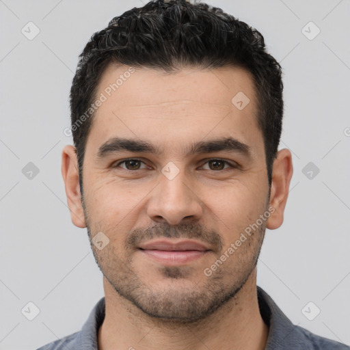 Joyful white young-adult male with short  black hair and brown eyes