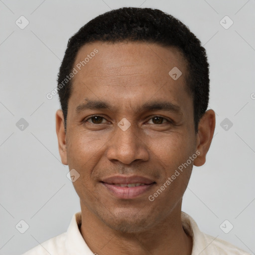 Joyful latino adult male with short  black hair and brown eyes