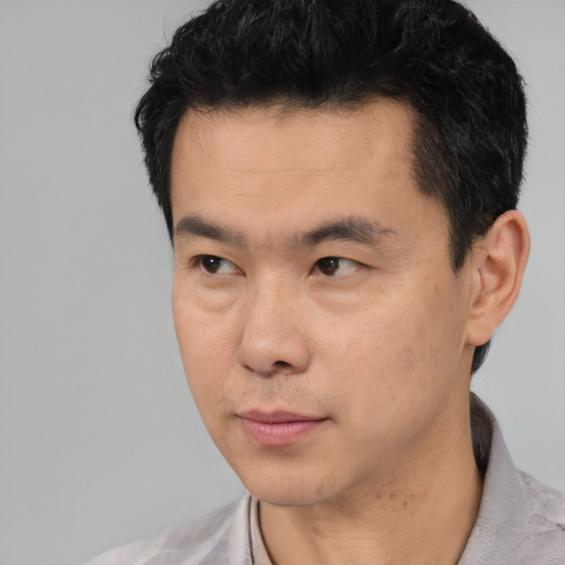 Neutral asian young-adult male with short  black hair and brown eyes