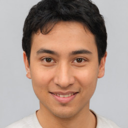 Joyful asian young-adult male with short  brown hair and brown eyes