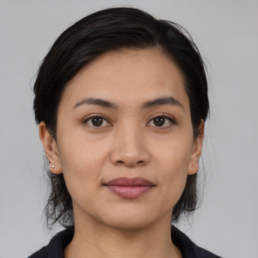 Joyful white young-adult female with medium  black hair and brown eyes
