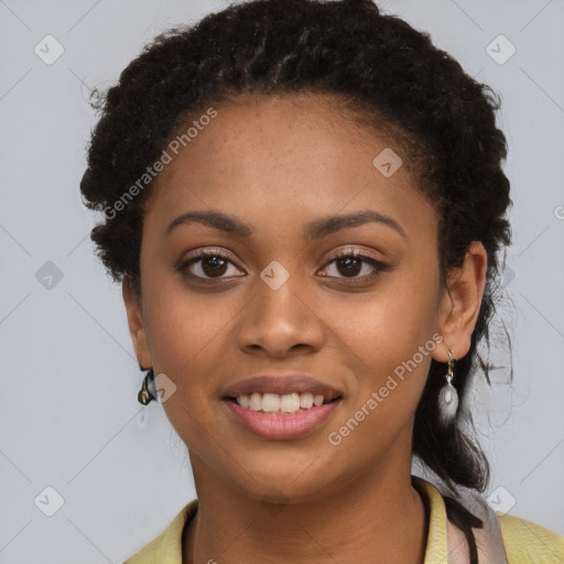 Joyful black young-adult female with long  black hair and brown eyes