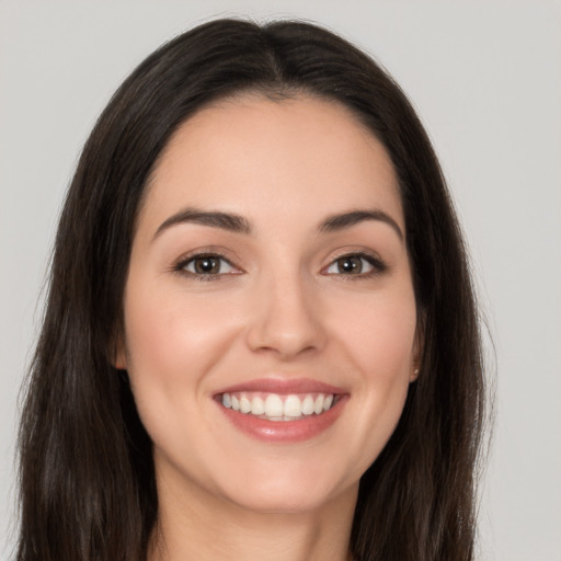 Joyful white young-adult female with long  brown hair and brown eyes