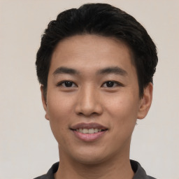 Joyful asian young-adult male with short  black hair and brown eyes