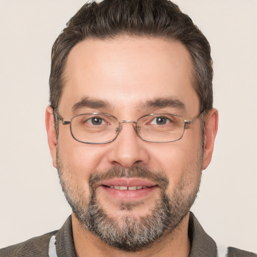 Joyful white adult male with short  brown hair and brown eyes