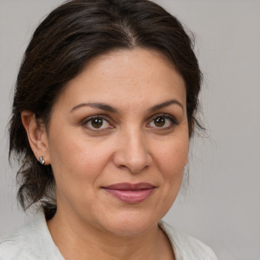 Joyful white adult female with medium  brown hair and brown eyes
