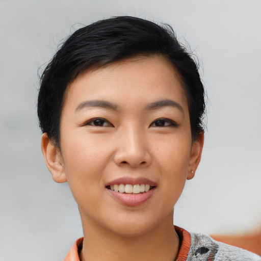 Joyful asian young-adult female with short  black hair and brown eyes