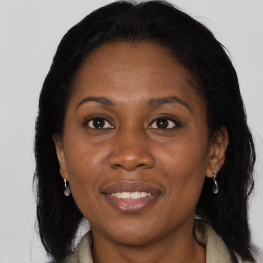Joyful black adult female with medium  black hair and brown eyes