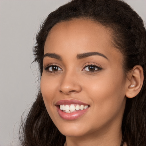 Joyful white young-adult female with long  brown hair and brown eyes