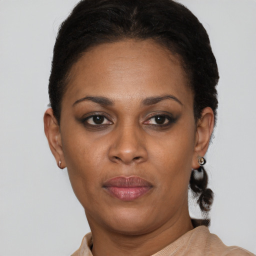 Joyful black adult female with short  brown hair and brown eyes