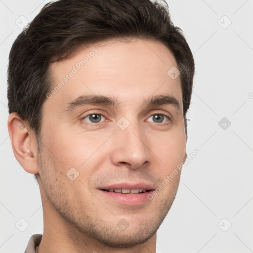 Joyful white young-adult male with short  brown hair and grey eyes