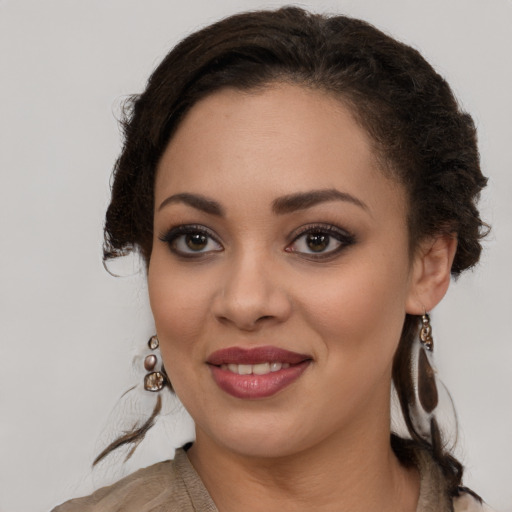 Joyful black young-adult female with medium  brown hair and brown eyes