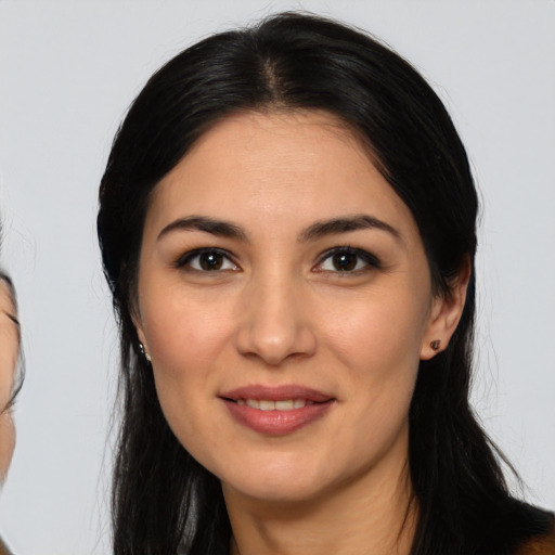 Joyful latino young-adult female with long  black hair and brown eyes