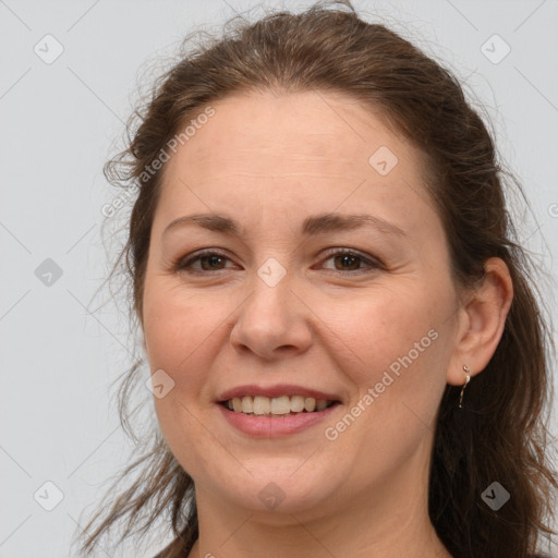 Joyful white adult female with long  brown hair and brown eyes