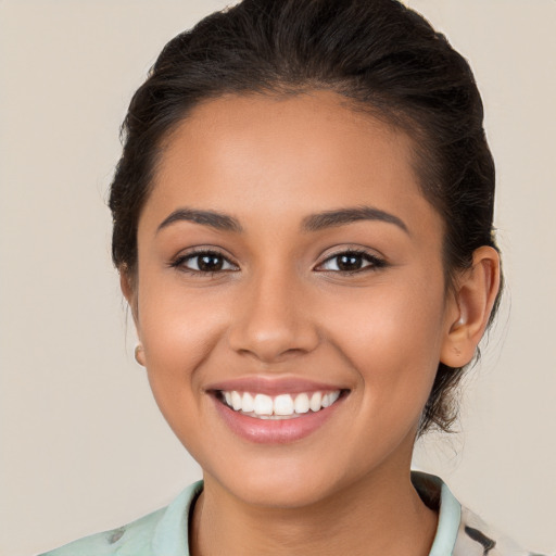 Joyful latino young-adult female with medium  brown hair and brown eyes