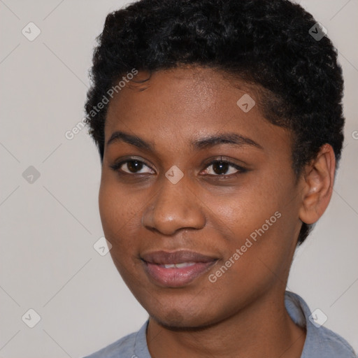 Joyful black young-adult female with short  black hair and brown eyes