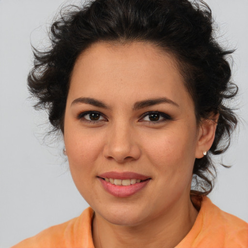Joyful latino young-adult female with medium  brown hair and brown eyes