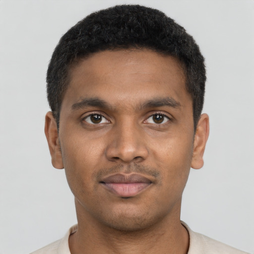Joyful black young-adult male with short  black hair and brown eyes