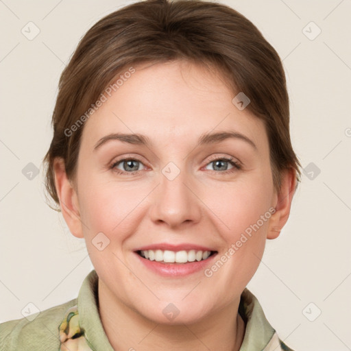 Joyful white young-adult female with medium  brown hair and grey eyes