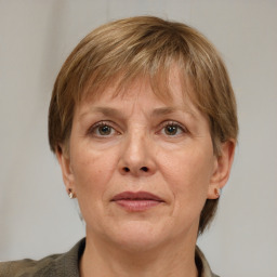 Joyful white adult female with medium  brown hair and grey eyes