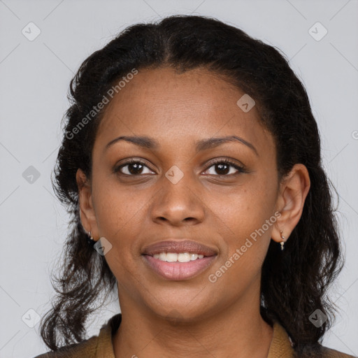 Joyful black young-adult female with long  brown hair and brown eyes