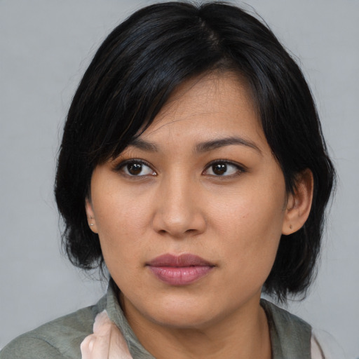 Joyful asian young-adult female with medium  black hair and brown eyes