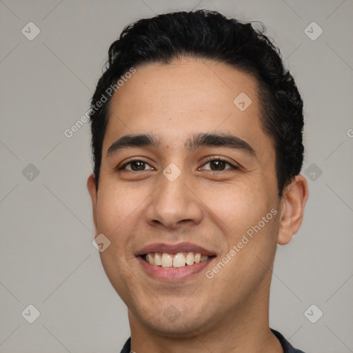 Joyful white young-adult male with short  black hair and brown eyes