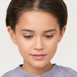 Joyful white child female with short  brown hair and brown eyes