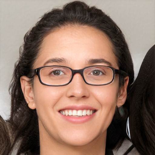 Joyful white adult female with long  brown hair and brown eyes