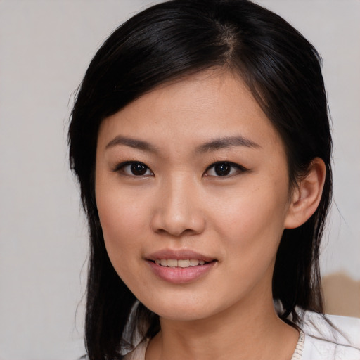 Joyful asian young-adult female with medium  black hair and brown eyes