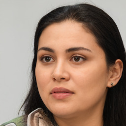 Joyful latino young-adult female with long  black hair and brown eyes