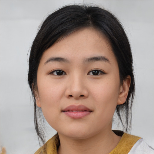 Joyful asian young-adult female with medium  brown hair and brown eyes