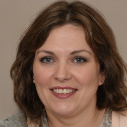 Joyful white adult female with medium  brown hair and grey eyes