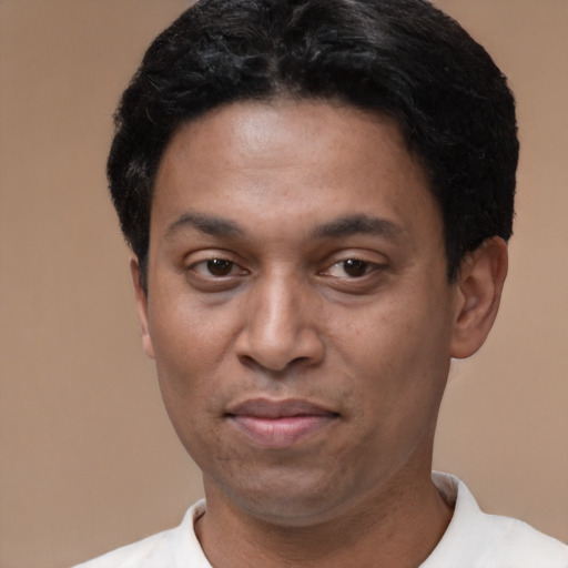 Joyful latino adult male with short  black hair and brown eyes