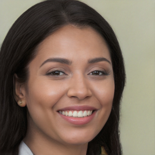 Joyful latino young-adult female with long  brown hair and brown eyes