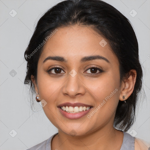 Joyful latino young-adult female with medium  brown hair and brown eyes