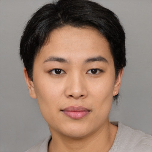 Joyful asian young-adult female with short  brown hair and brown eyes