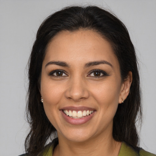 Joyful latino young-adult female with medium  brown hair and brown eyes