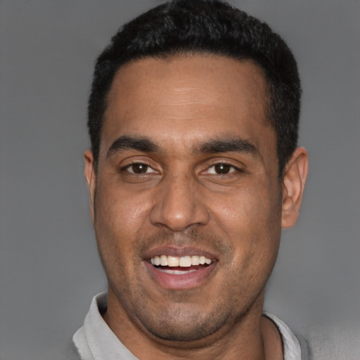 Joyful black young-adult male with short  black hair and brown eyes