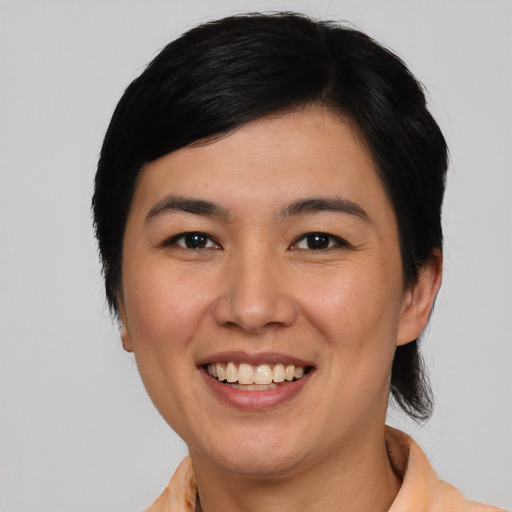 Joyful white young-adult female with short  black hair and brown eyes