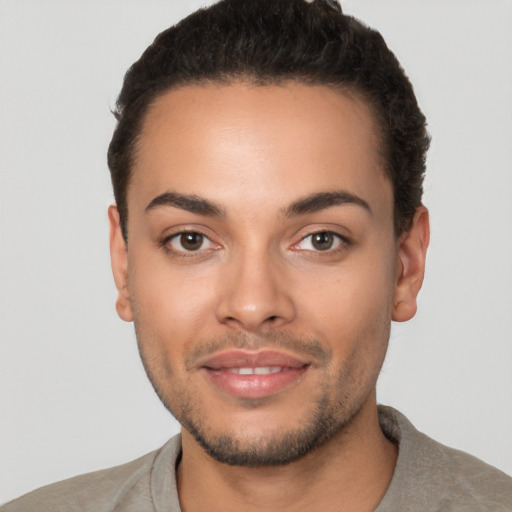 Joyful latino young-adult male with short  brown hair and brown eyes