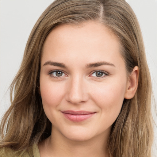 Joyful white young-adult female with long  brown hair and grey eyes