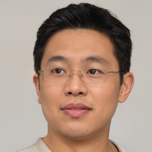Joyful asian adult male with short  brown hair and brown eyes