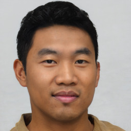 Joyful asian young-adult male with short  black hair and brown eyes