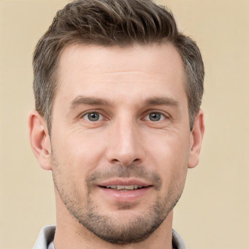 Joyful white adult male with short  brown hair and brown eyes