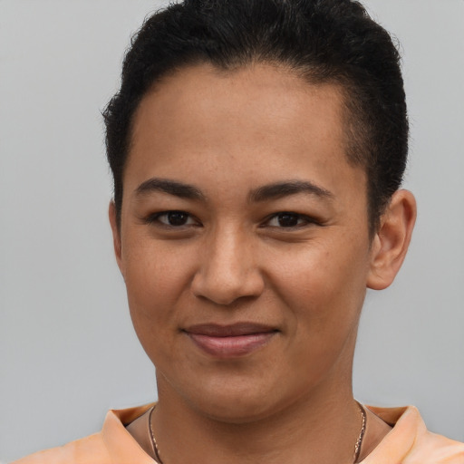 Joyful latino young-adult female with short  brown hair and brown eyes
