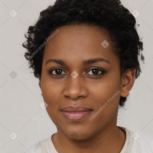 Joyful black young-adult female with short  black hair and brown eyes