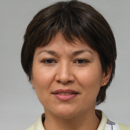 Joyful white adult female with medium  brown hair and brown eyes