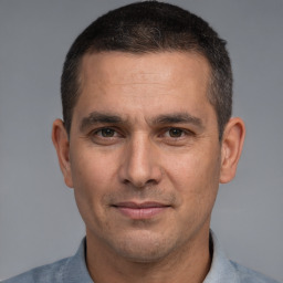 Joyful white adult male with short  brown hair and brown eyes