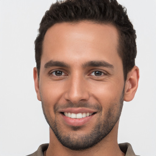 Joyful white young-adult male with short  brown hair and brown eyes